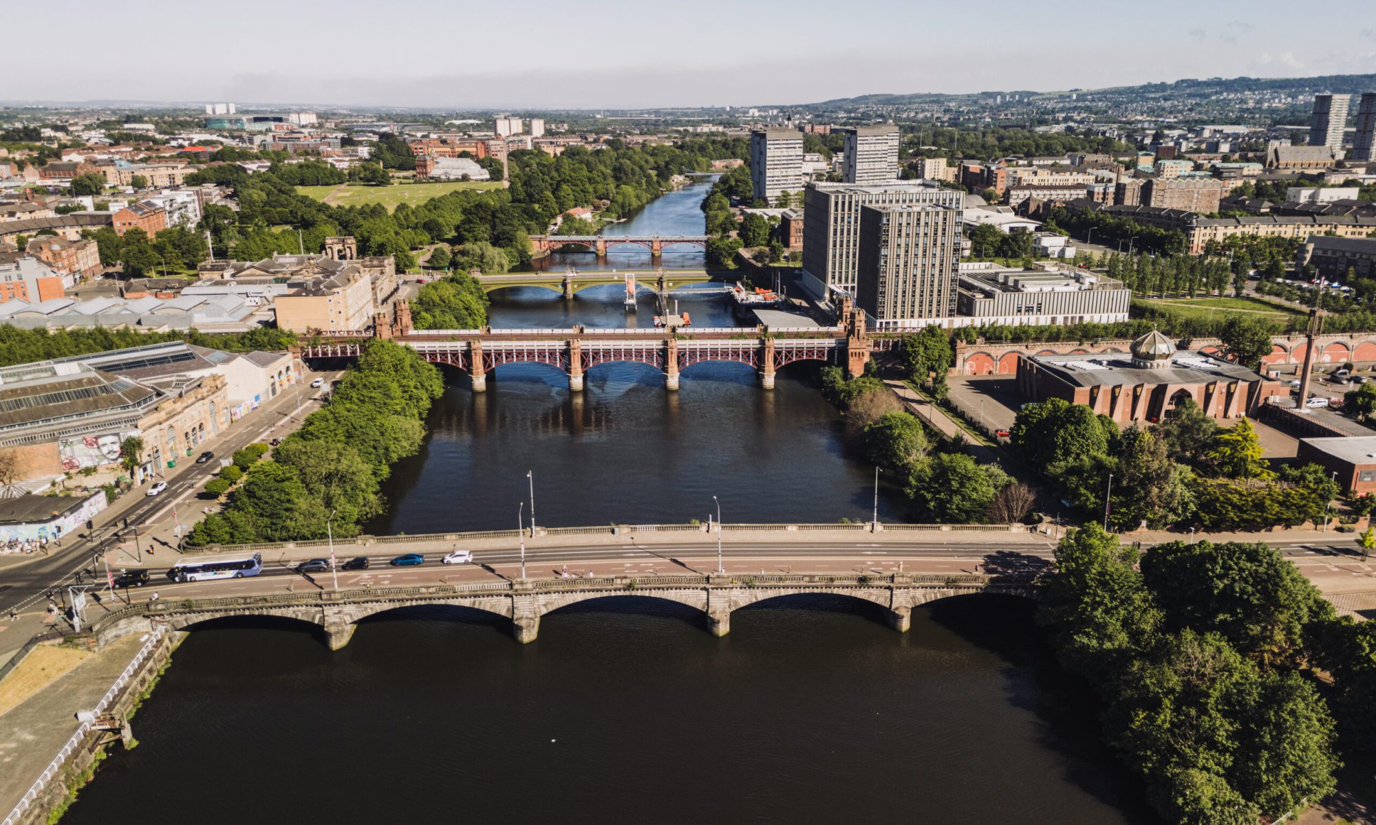 Glasgow Scotland: 18th May 2025: Drone photo of River Clyde bridges with City of Glasgow College exterior on sunny day nautical training facility